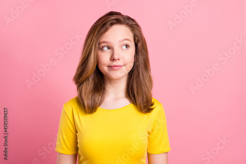 Photo of young attractive girl happy positive smile think dream look empty space isolated over pink color background