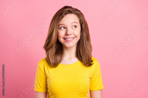 Photo of young cheerful girl happy positive smile think curious look empty space isolated over pink color background