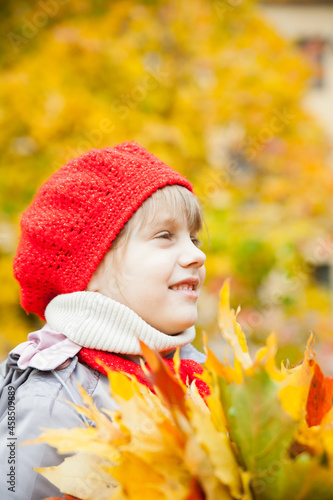 Girl  in   hat with autumn leaves