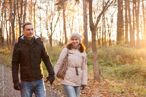  couple on walk in autumn park.