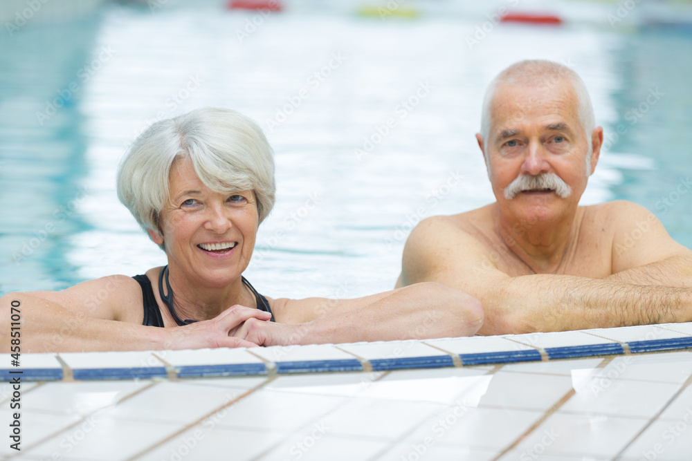 Fototapeta premium happy senior couple swimming in the pool