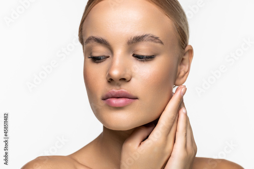 Beautiful young girl with a light natural make-up and perfect skin. Beauty face on a white background.