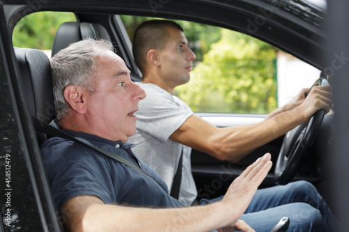 Fotografie men during moment of car accident inside of a car
