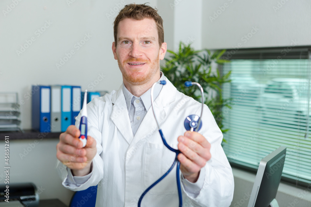 doctor showing a digital thermometer doctor showing a digital thermometer