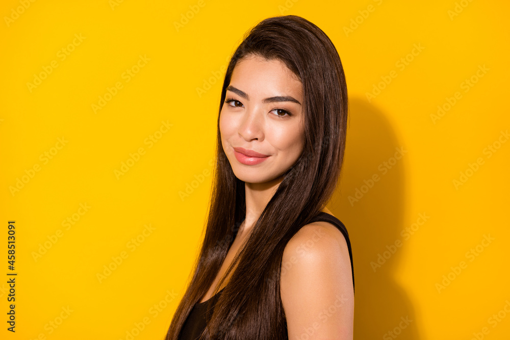 Photo of adorable stunning young asian woman brown hair charming face isolated on shine yellow color background Photo of adorable stunning young asian woman brown hair charming face isolated on shine yellow color background