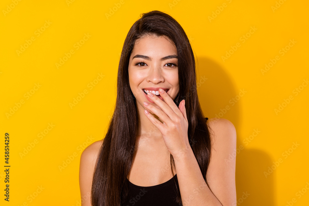 Full size photo of joyful happy nice young woma hold hand mouth laugh smile isolated on yellow color background Full size photo of joyful happy nice young woma hold hand mouth laugh smile isolated on yellow color background