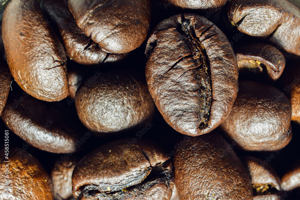 Close-up of brown coffee beans with details cracked by heat. Coffee background, poster, wall painting.
Close-up of brown coffee beans with details cracked by heat. Coffee background, poster, wall painting.