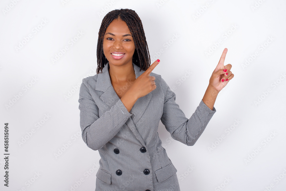 Positive MODEL with beaming smile pointing with two fingers and looking on empty copy space. Advertisement concept. Positive MODEL with beaming smile pointing with two fingers and looking on empty copy space. Advertisement concept.