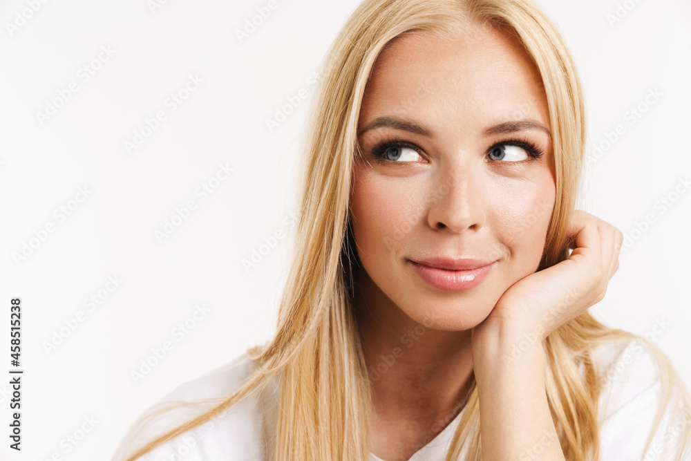 Young blonde woman in t-shirt posing and looking aside Young blonde woman in t-shirt posing and looking aside