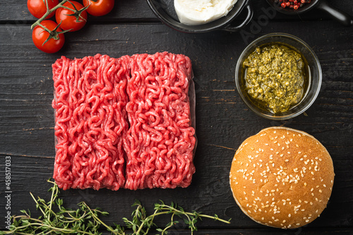 Home Raw Minced Beef Meatball burgers ingredients, on black wooden table background, top view flat lay