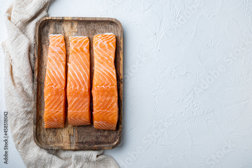 Fresh raw salmon fillet, on white textured background, flat lay with space for text