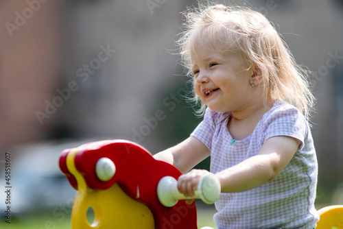 Toddler girl playing on playground