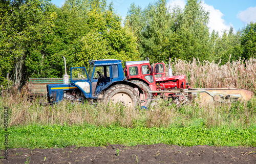 Wheeled agricultural tractors working at the potato plantation