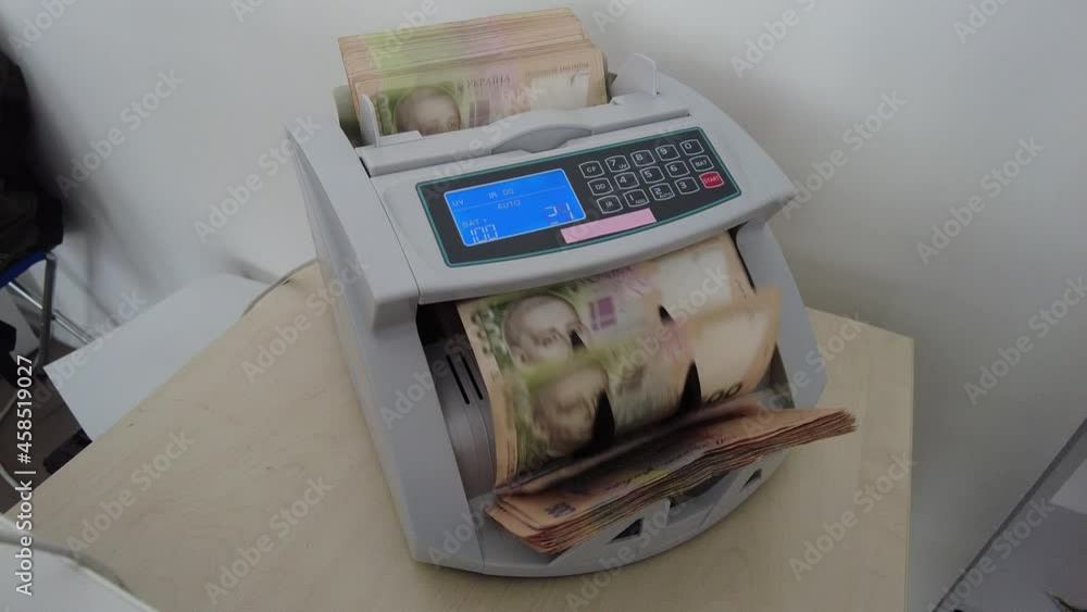 Counting machine for banknotes. Ukrainian money in a calculating machine. Conversion of the Ukrainian currency. Ukrainian money is counted by a machine for banknotes. Ukrainian hryvnia. Counting machine for banknotes. Ukrainian money in a calculating machine. Conversion of the Ukrainian currency. Ukrainian money is counted by a machine for banknotes. Ukrainian hryvnia.
