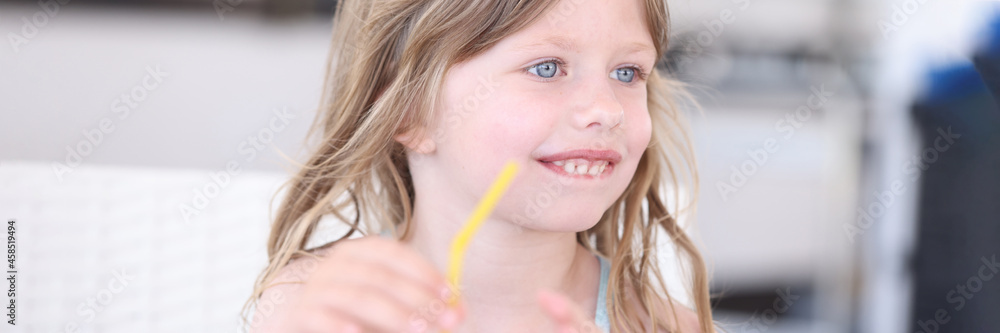 Little girl in swimsuit drinking cocktail from straw on beach Little girl in swimsuit drinking cocktail from straw on beach