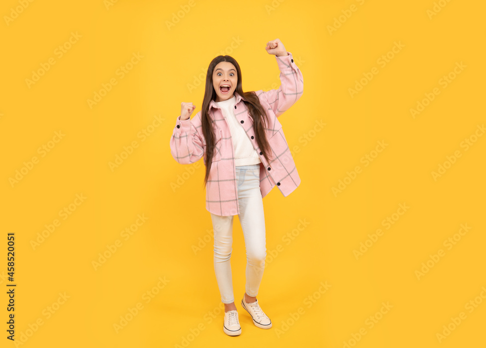 concept of success. autumn fashion. happy teen girl in pink checkered shirt. kid casual style. concept of success. autumn fashion. happy teen girl in pink checkered shirt. kid casual style.