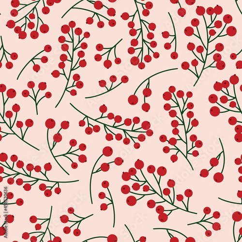 Seamless christmas pattern with rowan berries and green branches on a pale pink background. Autumn vector illustration background for surface design projects.