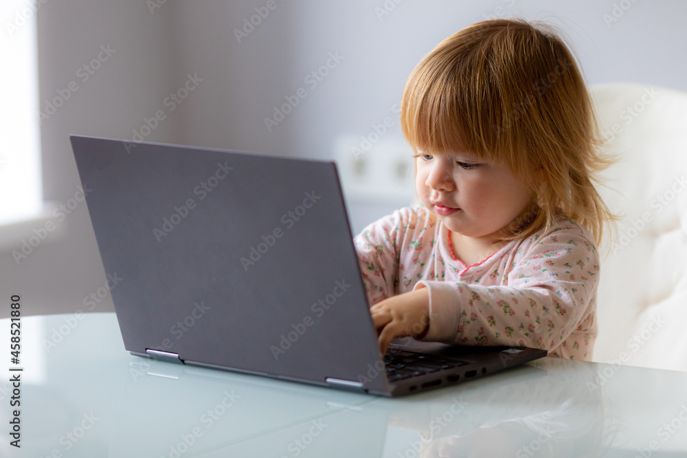 funny photo - baby with laptop on remote work, learning funny photo - baby with laptop on remote work, learning