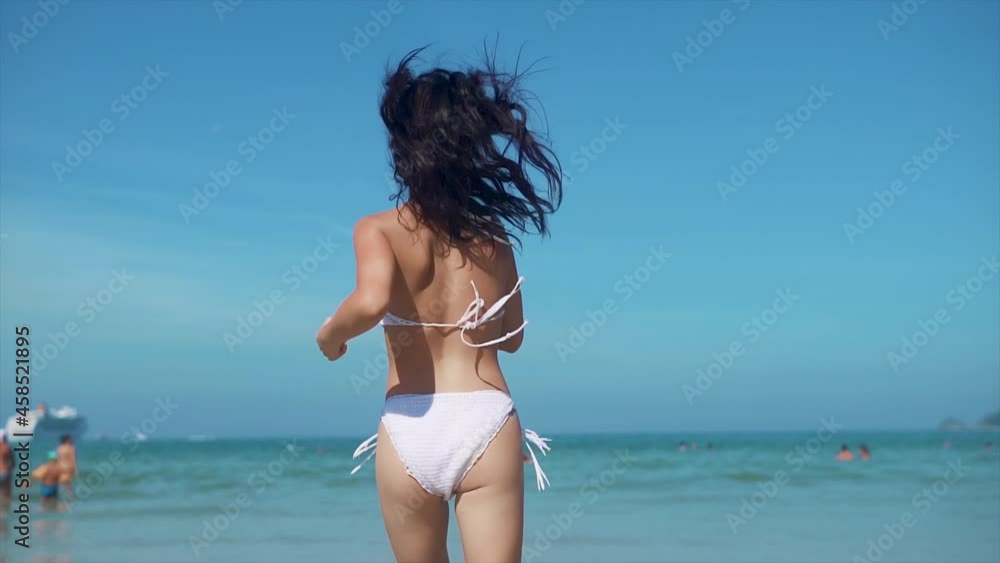 Beautiful woman running at the sea. Tourism and recreation in Thailand. Charming cute Asian woman travel around the islands. The girl enjoy life and has fun. Paradise beaches and white sand Beautiful woman running at the sea. Tourism and recreation in Thailand. Charming cute Asian woman travel around the islands. The girl enjoy life and has fun. Paradise beaches and white sand