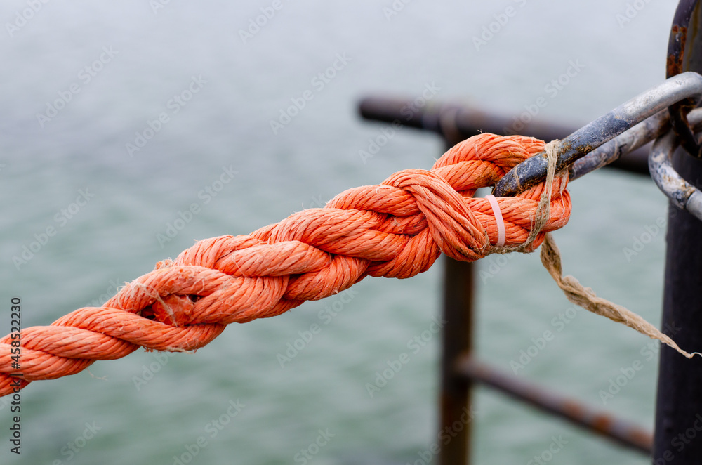 Marine rope. Synthetic rope fence. Metal carabiner. Cable. Knot. Marine rope. Synthetic rope fence. Metal carabiner. Cable. Knot.