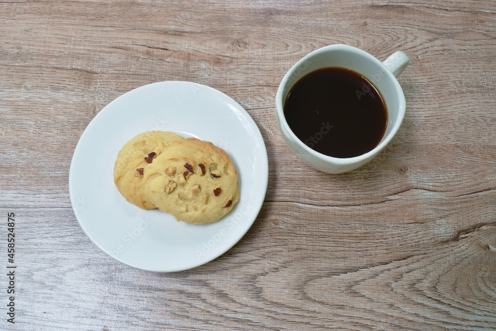 mixed nut cookie and black coffee cup on table mixed nut cookie and black coffee cup on table