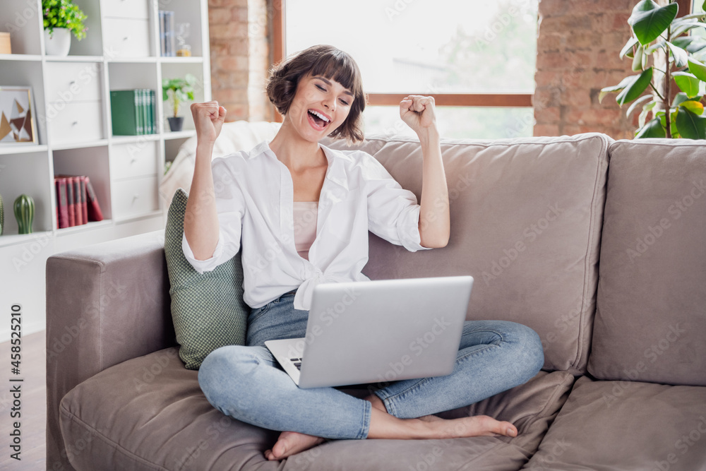 Full length body size photo female student using laptop gesturing like winner staying at home Full length body size photo female student using laptop gesturing like winner staying at home