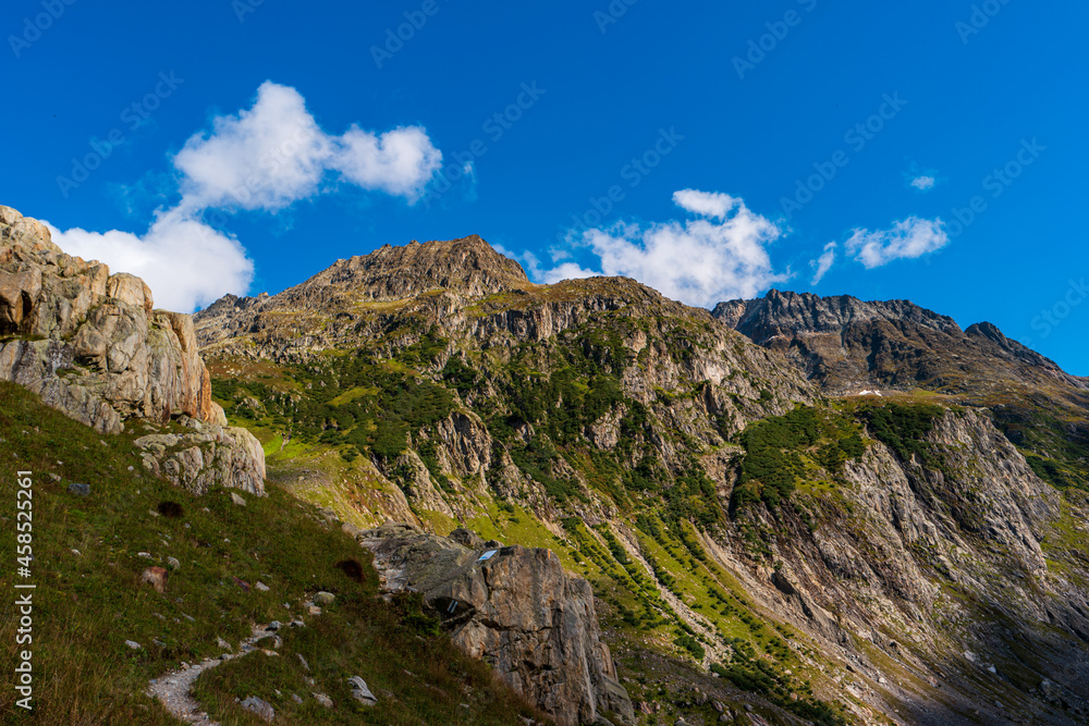 Grand scenic mountain vistas in the Swiss Alps. Summer, clouds, blue sky, no people.