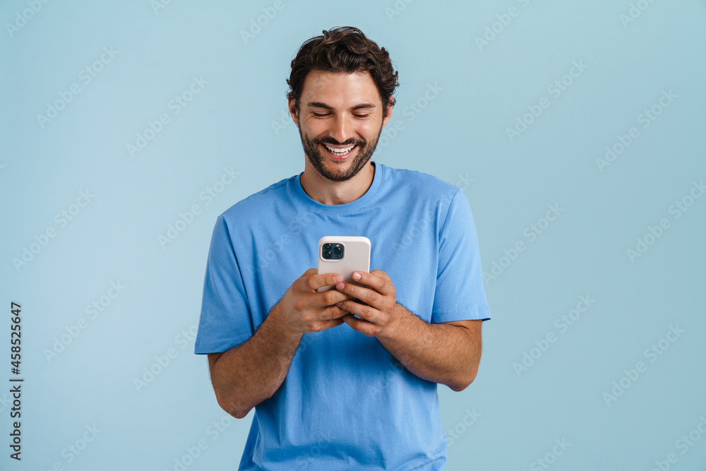 Young brunette man with bristle smiling and looking aside Young brunette man with bristle smiling and looking aside