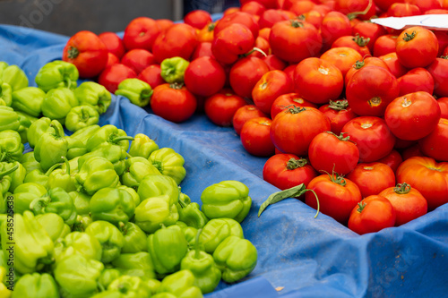 Fototapeta Naklejka Na Ścianę i Meble -  Green bell peppers and tomatoes on vegetable market.