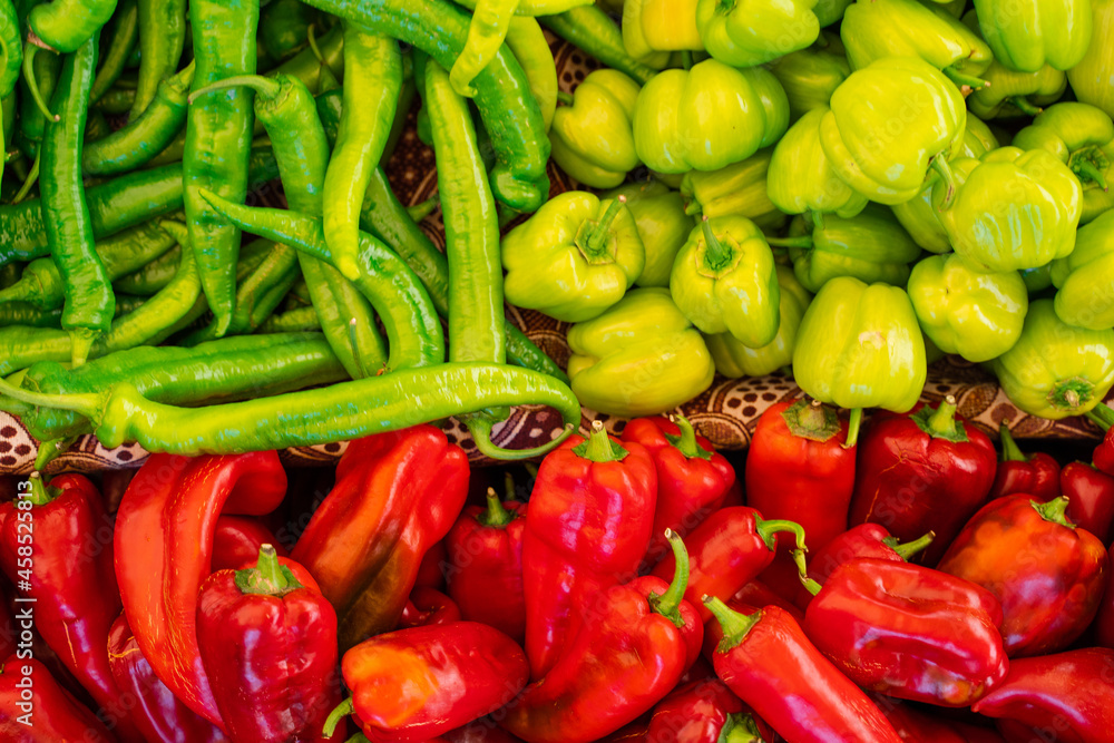 Mix of chili peppers, bell peppers, capi color assortment on vegetable market. Mix of chili peppers, bell peppers, capi color assortment on vegetable market.