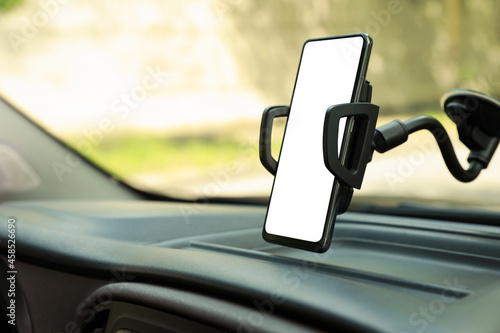 Fotografía Car holder with modern mobile phone on windshield of automobile
