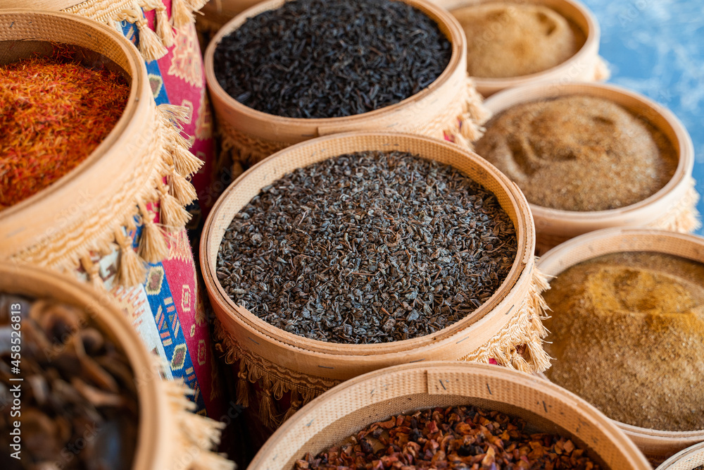 Assortment of Turkish spices and herbs in wooden bowls. Turkish market spices such as saffron, sumac and thyme. Cumin, rosemary and isot. Assortment of Turkish spices and herbs in wooden bowls. Turkish market spices such as saffron, sumac and thyme. Cumin, rosemary and isot.
