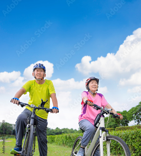 Asian healthy senior couple exercising with bicycles © Tom Wang