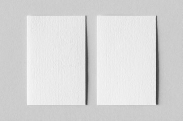 Textured business card mockup, vertical orientation. 55x85 mm.