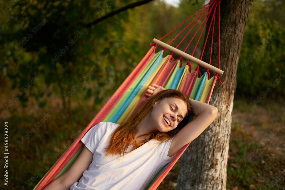 Fototapeta premium woman outdoors lies in a hammock vacation summer