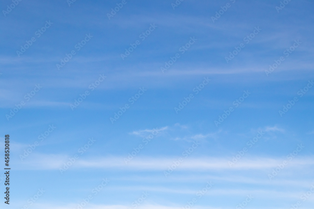 Clear blue sky with white cloud background