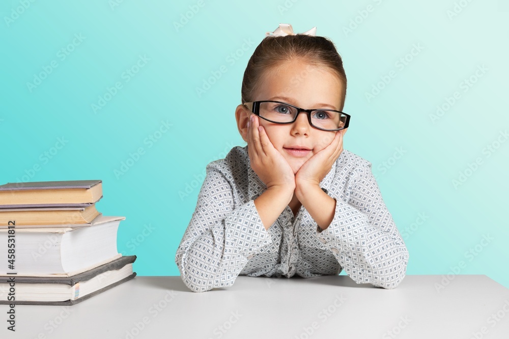 Young girl focused studying online class, writing notes with teacher video call conference Young girl focused studying online class, writing notes with teacher video call conference
