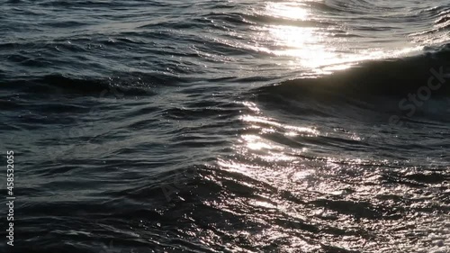 sunset sea summer wave in the evening with glare on the water and sunbeams
