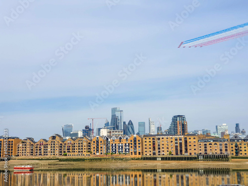 RAF Red Arrows fly over a still Thames and the City of London photo