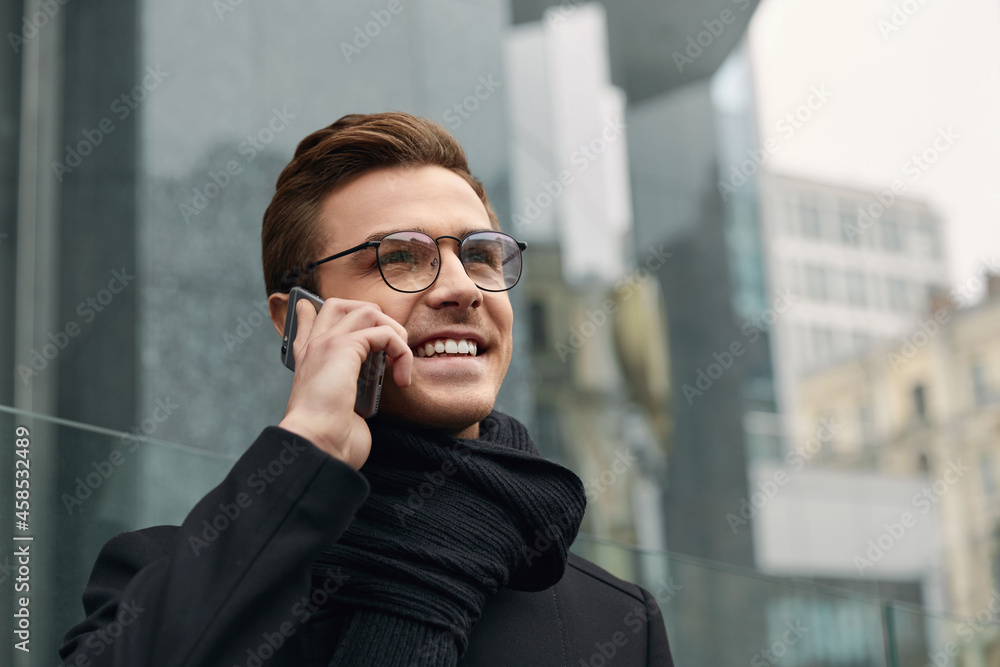 Young european businessman talking on mobile phone Young european businessman talking on mobile phone