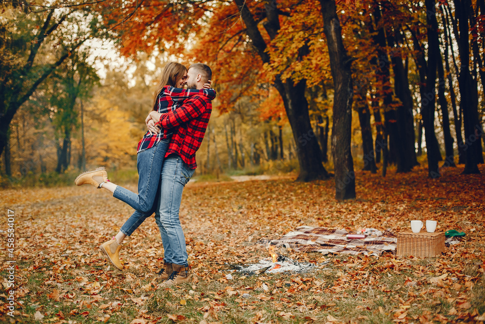 Elegant couple spend time in a autumn park Elegant couple spend time in a autumn park