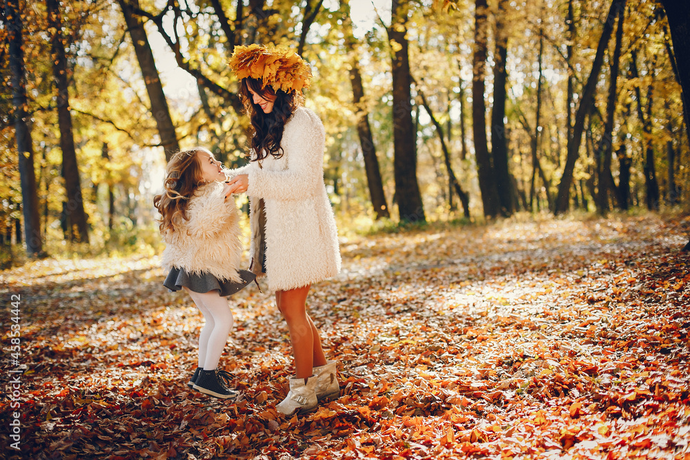 Cute and stylish family in a autumn park Cute and stylish family in a autumn park