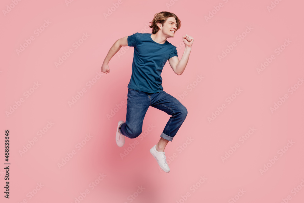 Profile portrait of funky sporty guy jump look empty space on pink background