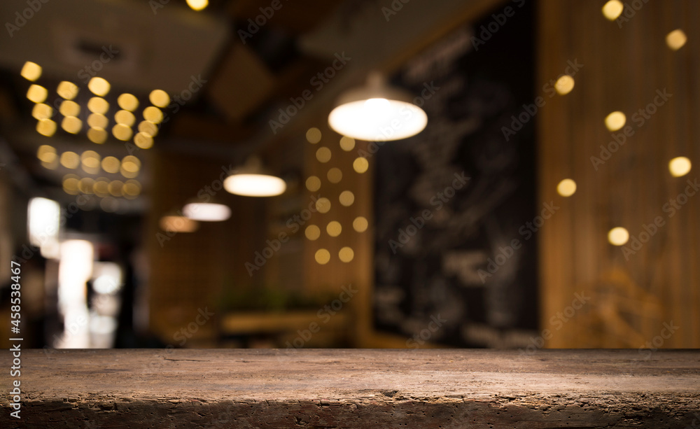 Empty dark wooden table in front of abstract blurred bokeh background of restaurant . can be used for display or montage your products.Mock up for space Empty dark wooden table in front of abstract blurred bokeh background of restaurant . can be used for display or montage your products.Mock up for space