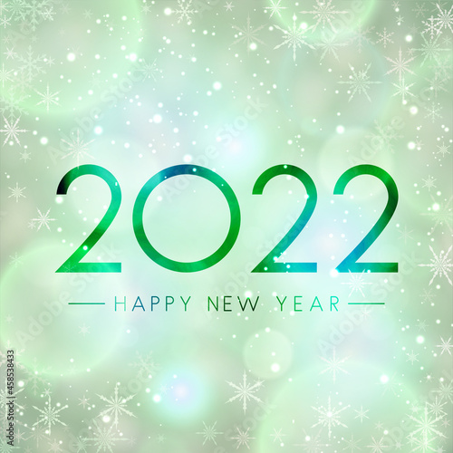 Fogged glass 2022 sign on bokeh snowflakes background.