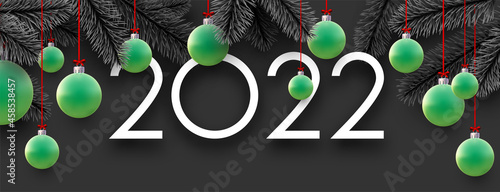 2022 sign with beautiful green Christmas bauble..