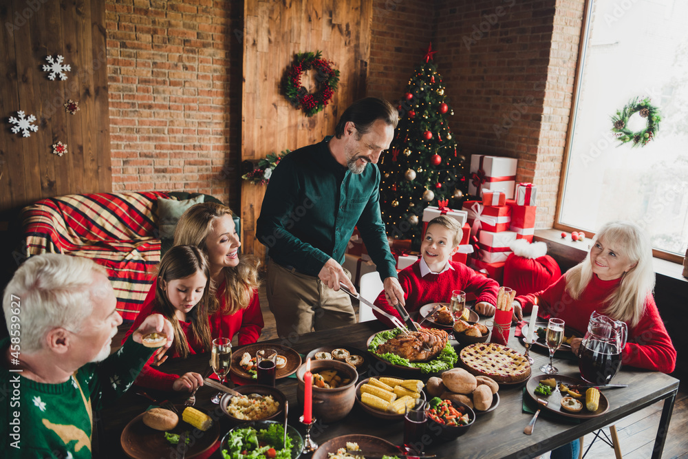 Portrait of nice cheerful family eating homemade dinner december eve noel custom at loft industrial home house indoors Portrait of nice cheerful family eating homemade dinner december eve noel custom at loft industrial home house indoors
