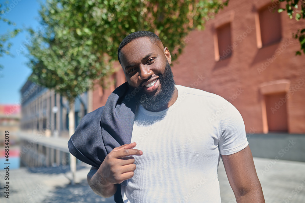 A dark-skinned man looking relaxed after a working day A dark-skinned man looking relaxed after a working day