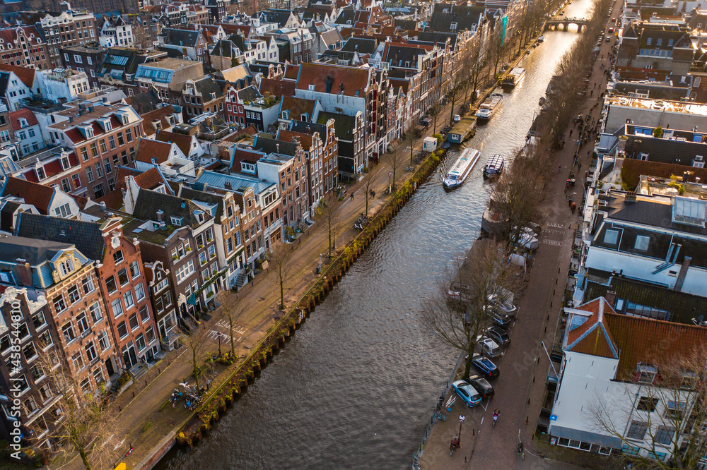 Canal Boat Tour Passing Through Amsterdam City Aerial View