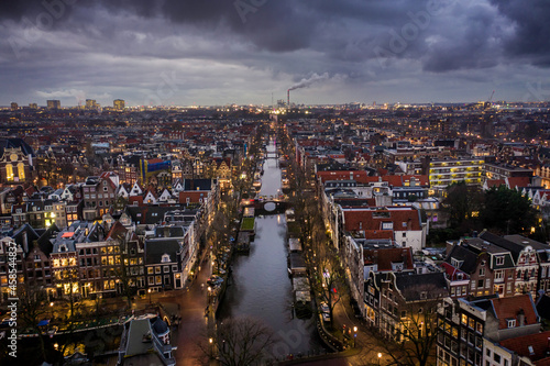 Amsterdam City Canals at Dusk with an Illuminated Skyline